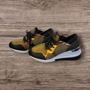 Michael Kors woman's Size 8.5 Gold and Black Wedged Sneakers